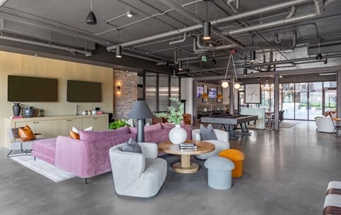 a living room with couches and chairs and a table